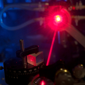 <span class=heading><b>Tunable solid-state lasers</b> by Alan Paterson</span><br />The image shows part of a typical solid-state laser cavity involving a prism to disperse the light. This research aims to put micro-devices into solid-state lasers to tune the nature of the outgoing beam of light. Such devices are smaller and cheaper than conventional methods and can be designed to perform any desired function.<br /><span class=small>Image: © 2016 Alan Paterson</span>.  <span class=small>Collaborators: Dr. Ralf Bauer (assisting), Dr. David Wilson (assisting) and Mr. Graham Wilson (photographer)</span>