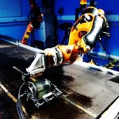 <span class=heading><b>Robotic Rolling Rumba</b> by Rahul Summan (Electronic and Electrical Engineering)</span><br />Ultrasonic inspection of aircraft composite structures is a critical stage in manufacture that ensures parts are within stringent safety limits. This image shows a KUKA KR5HW robot carrying out an automated ultrasonic inspection of a subscale wing component using an ultrasonic wheel probe which rolls over the surface. The robot appears to dance as it sweeps the probe over the component. <br /><span class=small>Image: © 2014 Rahul Summan</span>.  <span class=small>Collaborators: Maxim Morozov, Charles Macleod, Gareth Pierce, Spirit AeroSystems </span>