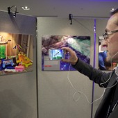 <span class=heading><b>Images of Research</b> by Guy Hinks</span><br /><p class=int>Judge Chris Thomson watches the ditigtal stories developed by entrants through augmented reality technology, Aurasma.</p><span class=small>Image: © 2024 Guy Hinks 2015</span>