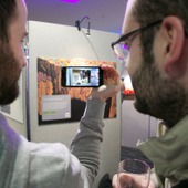 <span class=heading><b>Images of Research</b> by Guy Hinks</span><br /><p class=int>Delegates using the augmented reality technology app, Aurasma, to watch the researcher’s stories come to life on their phones!</p><span class=small>Image: © 2025 Guy Hinks 2015</span>