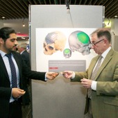 <span class=heading><b>Images of Research</b> by Guy Hinks</span><br /><p class=int>Winner of Innovation category, Mohammad Salamati, shows Professor Sir Jim McDonald the cranium implant used in his image.</p><span class=small>Image: © 2024 Guy Hinks 2015</span>