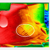 <span class=heading><b>Thermal Imaging of Die surface condition</b> by Xavier Baines (Design, Manufacture & Engineering Management)</span><br />The Image shown here is the surface of a die after a jet engine blade has been heated in the die for around 4 hours. The image is a capture of a thermal video which enables us to study the die condition and therefore, implement the production of these jet engine parts. For instance, we can see here in the white circled area the gradient change of colour which can indicate a chemical reaction between elements, which is a crucial issue of research to enhance these parts.<br /><span class=small>Image: © 2013 Xavier Baines</span>
